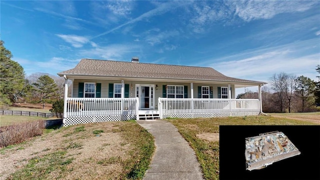 view of front of property with covered porch and a front lawn