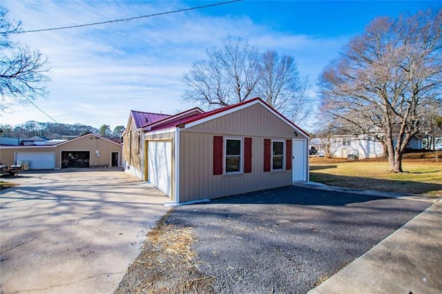 view of side of home featuring a garage and an outdoor structure