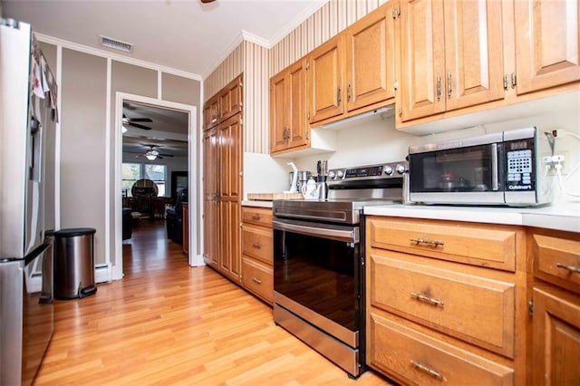 kitchen featuring appliances with stainless steel finishes, a baseboard radiator, ornamental molding, ceiling fan, and light hardwood / wood-style floors