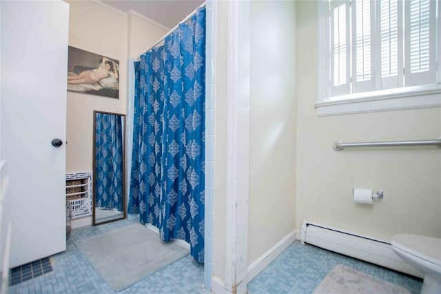 bathroom with curtained shower, baseboard heating, and toilet