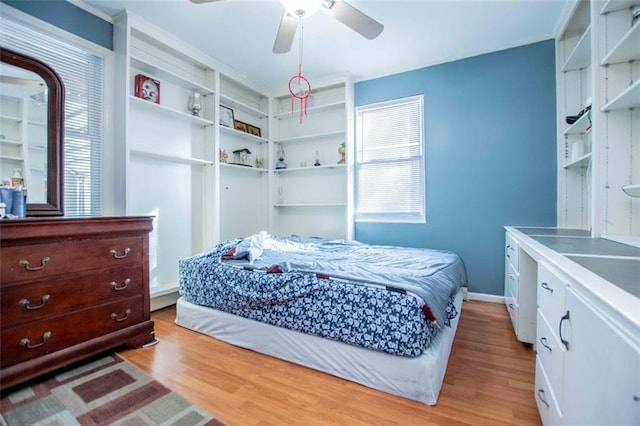 bedroom with multiple windows, ceiling fan, and light wood-type flooring