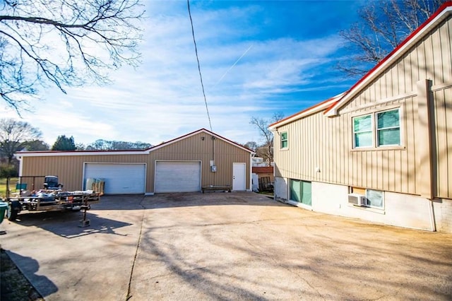 view of property exterior featuring a garage and an outdoor structure