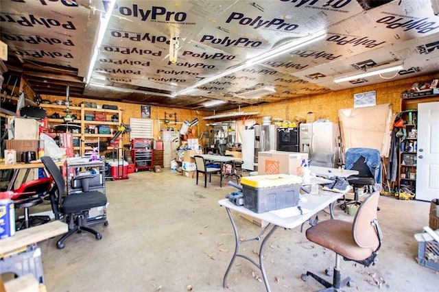 interior space featuring concrete flooring and a workshop area