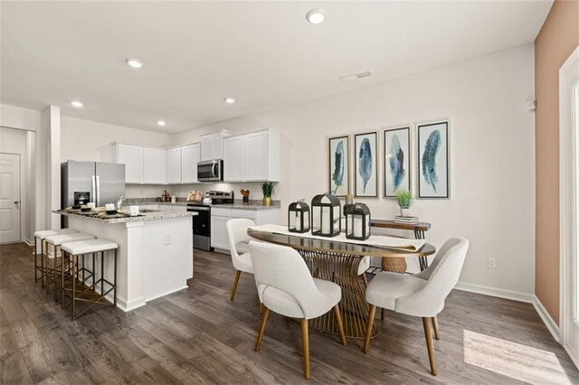 dining area featuring dark wood-type flooring and sink