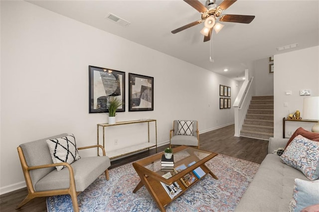 living room featuring hardwood / wood-style floors and ceiling fan