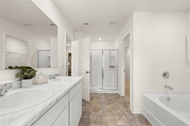 bathroom with vanity and separate shower and tub