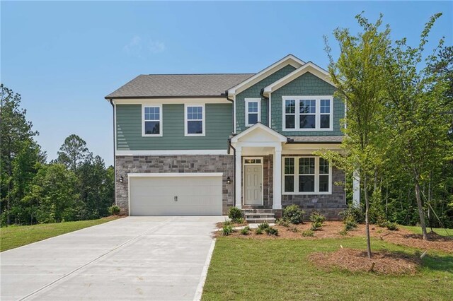7252 Eton Ln, Locust Grove, GA 30248 - craftsman-style house featuring a garage, driveway, a front yard, and stone siding