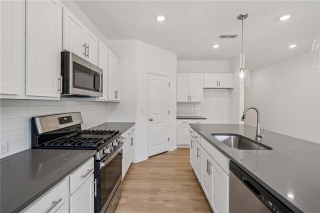7252 Eton Ln, Locust Grove, GA 30248 - kitchen with dark countertops and white cabinets