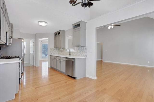 207 Amaranth Ct, Ball Ground, GA 30107 - kitchen featuring appliances with stainless steel finishes, gray cabinets, ceiling fan, decorative backsplash, and light countertops