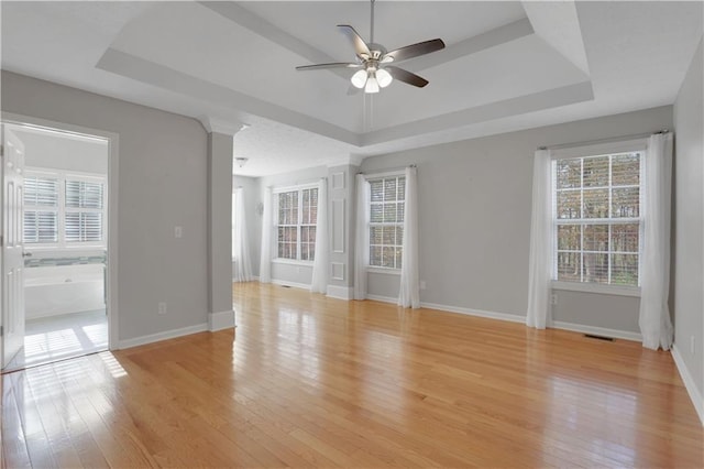 207 Amaranth Ct, Ball Ground, GA 30107 - unfurnished room with a tray ceiling, ceiling fan, and light wood-type flooring