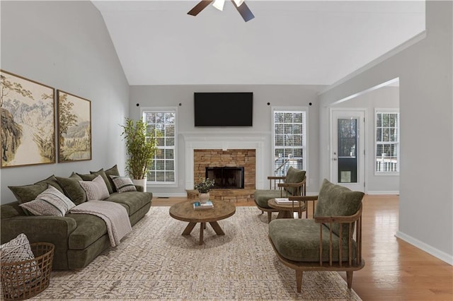 207 Amaranth Ct, Ball Ground, GA 30107 - living room with wood finished floors, ceiling fan, healthy amount of natural light, vaulted ceiling, and a stone fireplace