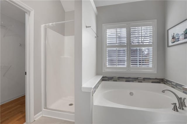 207 Amaranth Ct, Ball Ground, GA 30107 - full bathroom featuring a garden tub, a walk in closet, and a shower stall