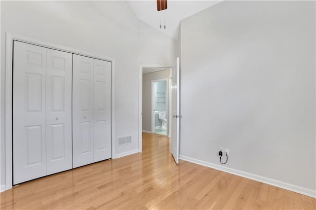 207 Amaranth Ct, Ball Ground, GA 30107 - unfurnished bedroom featuring light wood-style flooring, a closet, a ceiling fan, and high vaulted ceiling