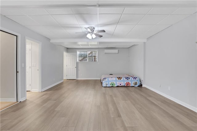 207 Amaranth Ct, Ball Ground, GA 30107 - bedroom with light wood-style flooring, a wall unit AC, a paneled ceiling, and ceiling fan
