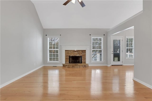 207 Amaranth Ct, Ball Ground, GA 30107 - unfurnished living room with a ceiling fan, plenty of natural light, light wood finished floors, a stone fireplace, and lofted ceiling