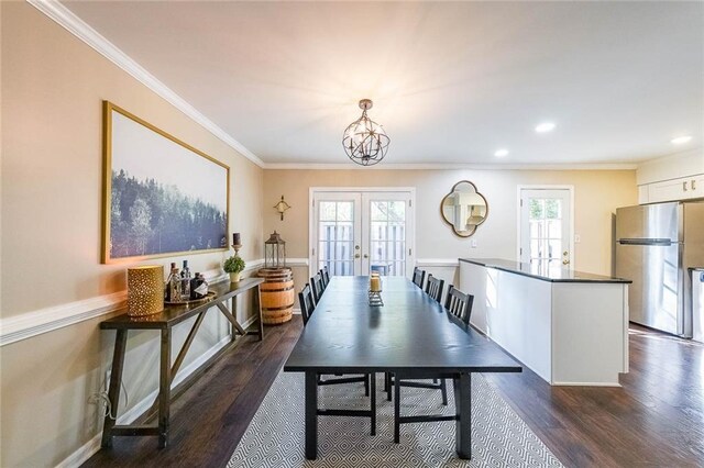 dining room with french doors, dark wood-type flooring, plenty of natural light, and ornamental molding