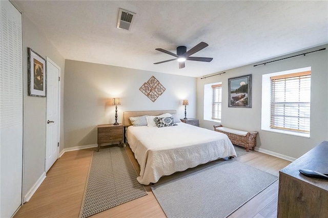 bedroom with light hardwood / wood-style floors and ceiling fan