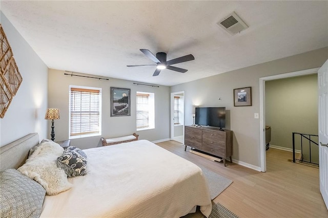 bedroom with light hardwood / wood-style flooring and ceiling fan