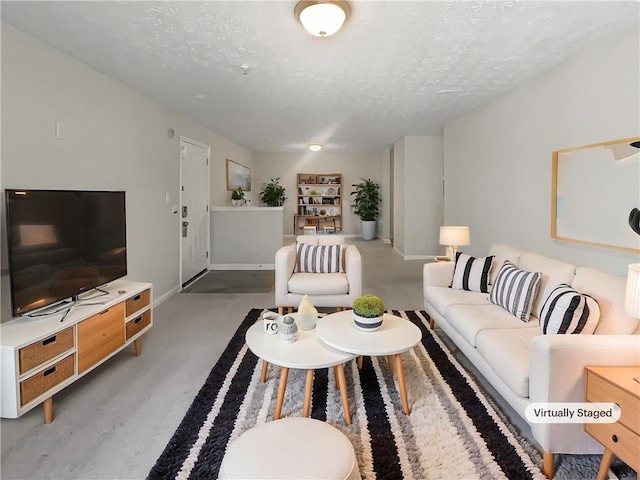 living room featuring baseboards and a textured ceiling