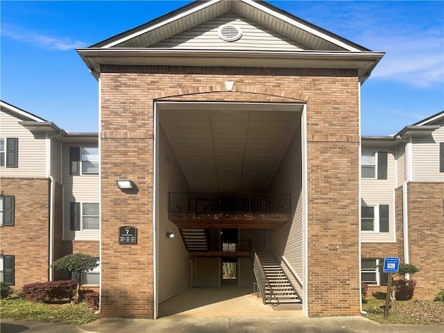 doorway to property featuring brick siding
