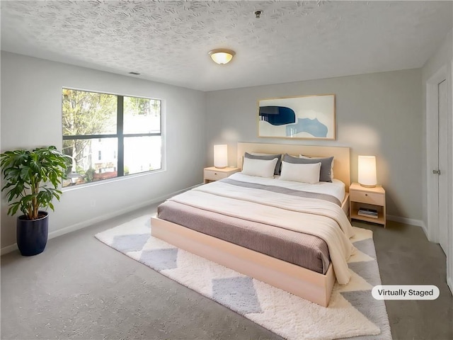 bedroom featuring baseboards and a textured ceiling