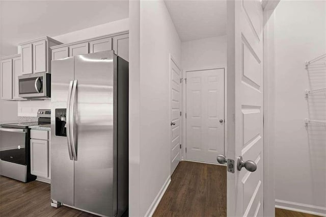 kitchen with stainless steel appliances and dark wood-type flooring