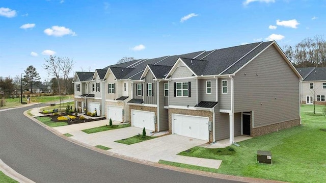 view of property featuring a front lawn and a garage