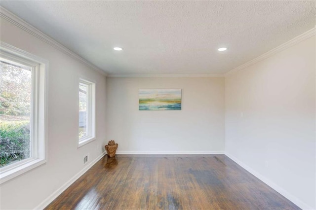 unfurnished room featuring a textured ceiling, dark hardwood / wood-style floors, a wealth of natural light, and ornamental molding