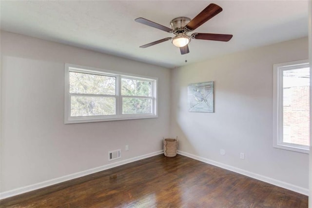 empty room featuring ceiling fan and dark hardwood / wood-style flooring