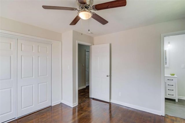 unfurnished bedroom with ceiling fan, dark hardwood / wood-style flooring, and a closet