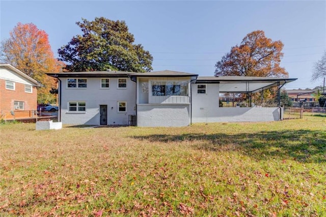 rear view of house with a lawn and central air condition unit