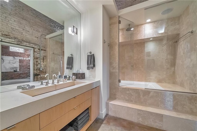 bathroom featuring vanity and tiled bath