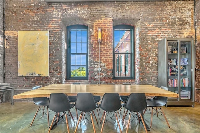 dining space with brick wall