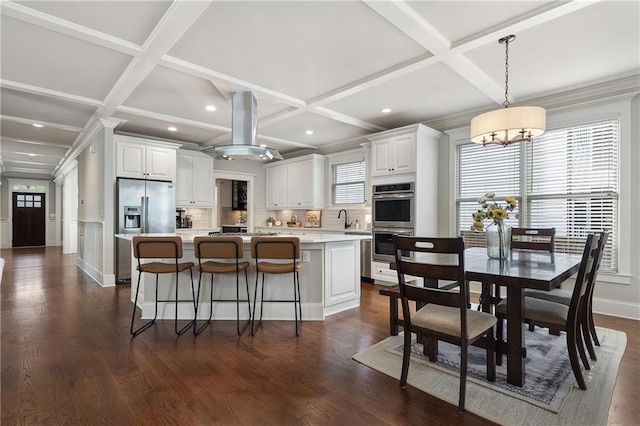 kitchen with tasteful backsplash, a center island, coffered ceiling, white cabinetry, and appliances with stainless steel finishes