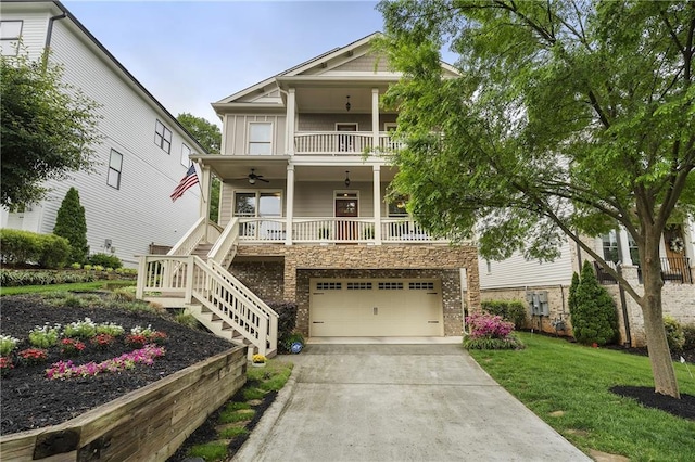 view of front of property with covered porch, a garage, driveway, a front lawn, and stairs