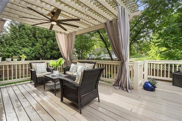 wooden deck with outdoor lounge area, a ceiling fan, and a pergola