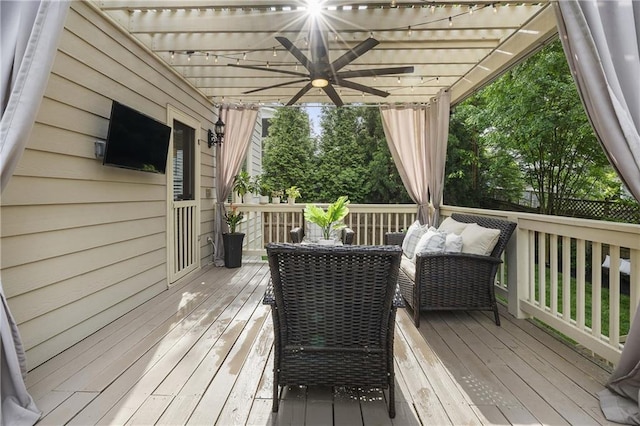 wooden terrace featuring a ceiling fan and a pergola