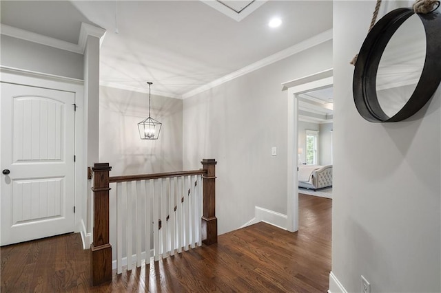 hallway featuring ornamental molding, recessed lighting, an upstairs landing, and wood finished floors
