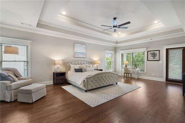 bedroom with baseboards, visible vents, ornamental molding, and a tray ceiling