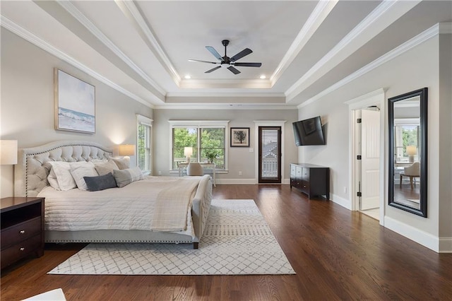 bedroom with dark wood-style flooring, a raised ceiling, and baseboards