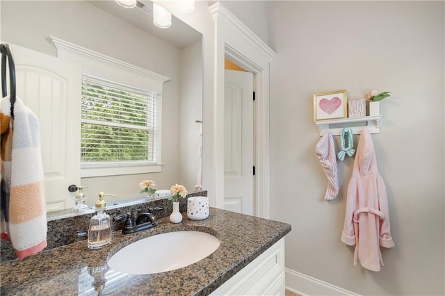 bathroom featuring vanity and baseboards