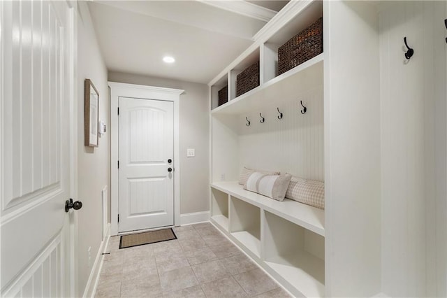 mudroom with baseboards, recessed lighting, and light tile patterned floors