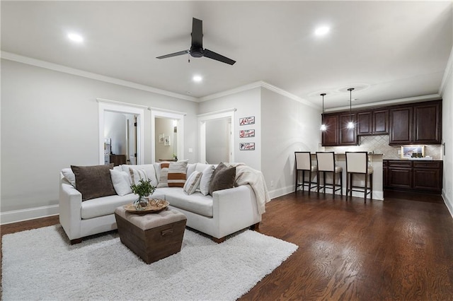 living room featuring ceiling fan, baseboards, recessed lighting, ornamental molding, and dark wood-type flooring
