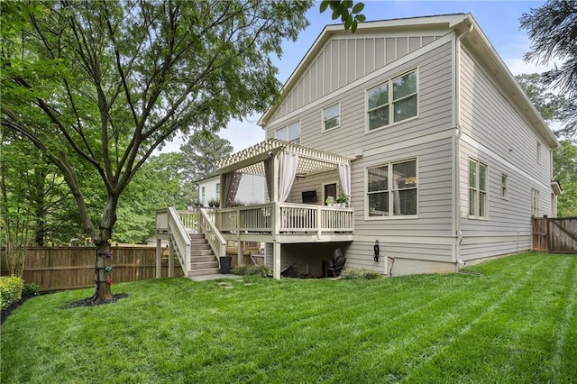 rear view of house with board and batten siding, a fenced backyard, a yard, a wooden deck, and a pergola