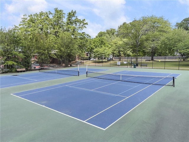 view of tennis court featuring fence and community basketball court