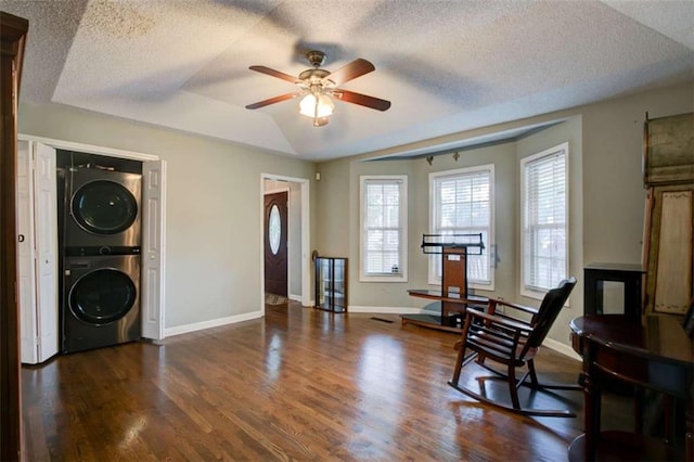 1137 Eagles Nest Cir, Carrollton, GA 30116 - living area featuring stacked washer / dryer, a ceiling fan, wood finished floors, and a textured ceiling