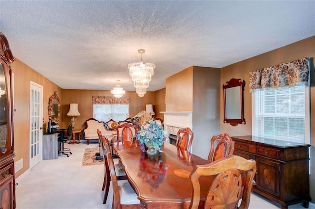 1137 Eagles Nest Cir, Carrollton, GA 30116 - dining room featuring a chandelier, light carpet, and a textured ceiling