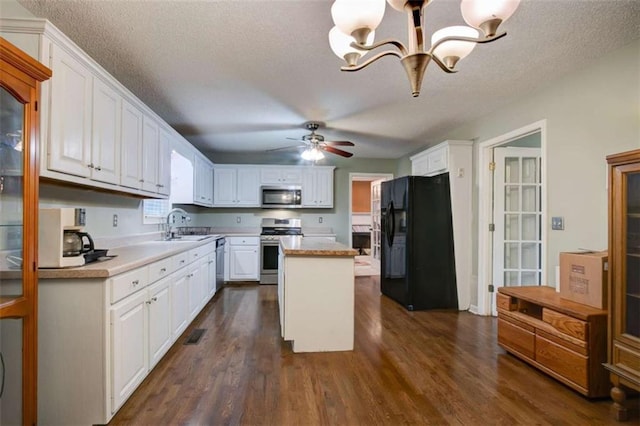 1137 Eagles Nest Cir, Carrollton, GA 30116 - kitchen featuring stainless steel appliances, white cabinetry, light countertops, and a textured ceiling