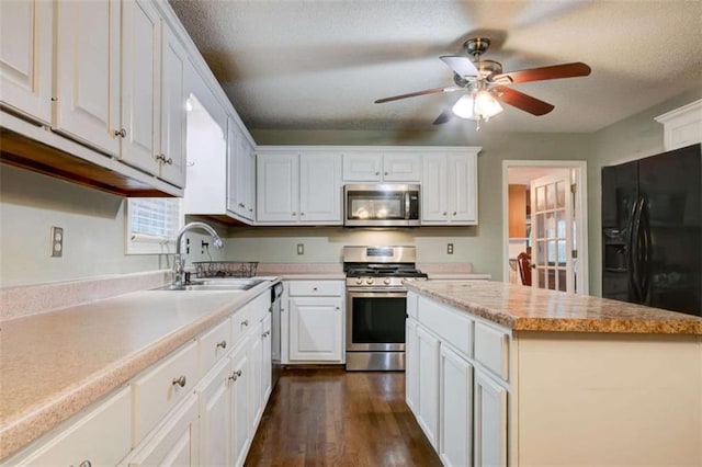 1137 Eagles Nest Cir, Carrollton, GA 30116 - kitchen featuring appliances with stainless steel finishes, light countertops, white cabinetry, and dark wood-type flooring