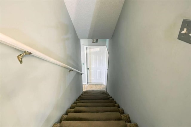 1137 Eagles Nest Cir, Carrollton, GA 30116 - staircase with a textured ceiling and baseboards